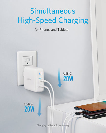 White charging adapter with two USB-C ports connected to a device, on a light gray background.