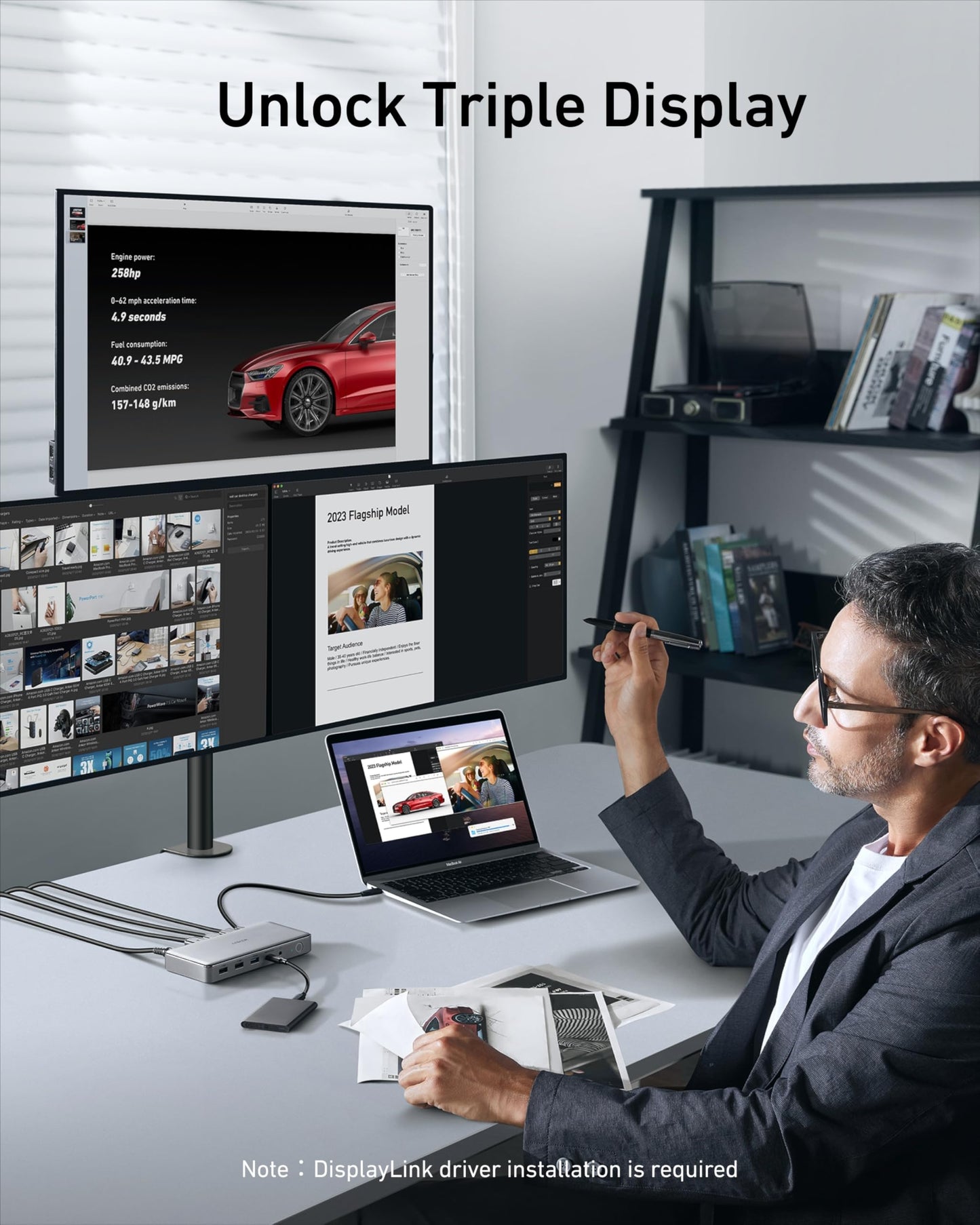 Man using a laptop with three monitors displaying different content in a home office setting.