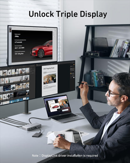 Man using a laptop with three monitors displaying different content in a home office setting.
